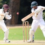 Two cricket players in action on a sunny day, showcasing skillful batting and wicket-keeping.